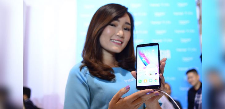  SEorang model memperagakan penggunaan HP Honor 9 Lite.