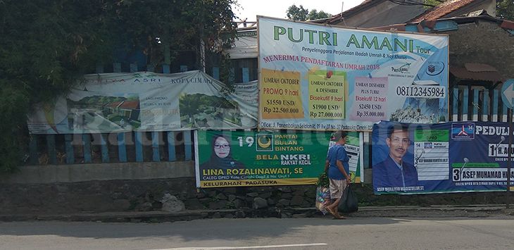 MASA TENANG : APK Caleg Kontestan Pemilu 2019 yang masih terpasang di Jalan Dustira, Kota Cimahi, Minggu (14/4/2019). 
(foto: WHISNU PRADANA/RADAR BANDUNG)
