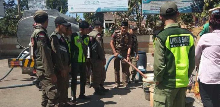 DISTRIBUSI : Satpol PP Kecamatan Paseh bersama tim siaga 7 Majalaya melaksanakan pendistribusian air bersih bagi masyarakat yang kekurangan air bersih, Senin (29/7/2019). (foto : DEDEN KUSDINAR/RADAR BANDUNG)