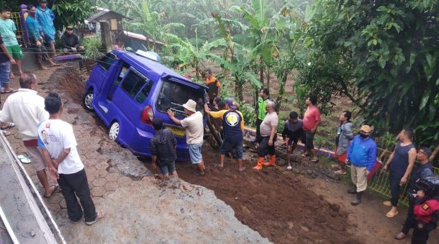 EVAKUASI : Warga Kampung Warung Kawung RT 002/06 Desa Cisarua, Kacamatan Nagrak saat mengevakuasi angkutan umum yang terseret longsor. (foto: IST)